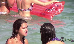 Two italian beauties playing beneath the water on the topless beach